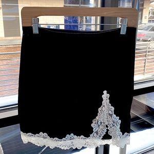 never worn before, size 4, adorable black mini skirt with lace and slit